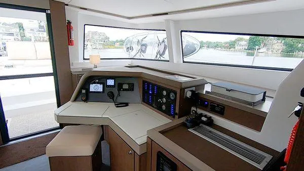 Joy Yacht Photos Pics Modern helm station of 2021 Bali 5.4 catamaran with navigation equipment and panoramic windows.