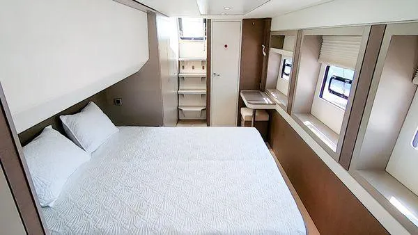 Joy Yacht Photos Pics Luxurious cabin interior of 2021 Bali 5.4 yacht with bed and windows.