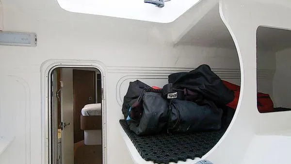 Joy Yacht Photos Pics Interior of a 2021 Bali 5.4 yacht with luggage on a shelf.