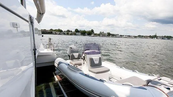 Joy Yacht Photos Pics Inflatable boat Bali 5.4 (2021) docked on calm water with scenic shoreline view.