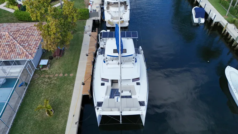 Joy Yacht Photos Pics Aerial view of a 2021 Bali 5.4 catamaran docked by a canal.