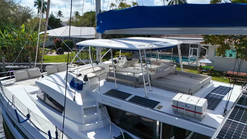 Joy Yacht Photos Pics 2021 Bali 5.4 catamaran with solar panels, spacious deck, and outdoor seating.