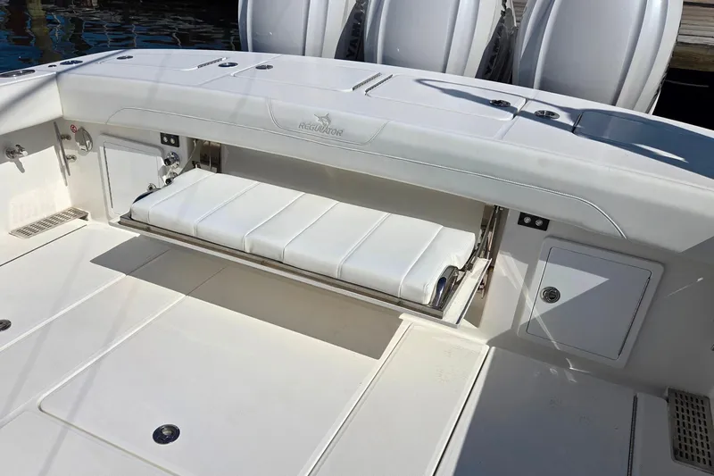  Yacht Photos Pics 2022 Regulator 37 boat with fold-out seating and storage compartments.