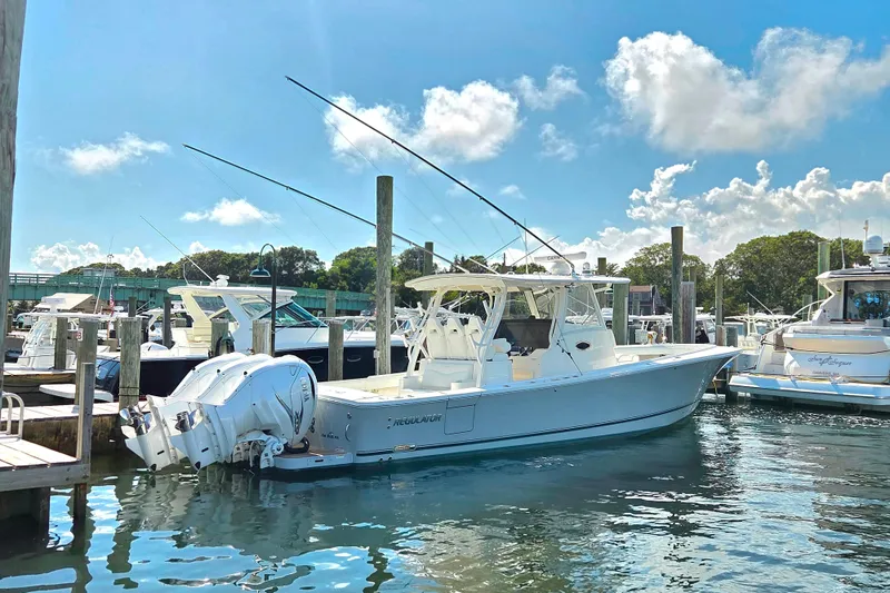  Yacht Photos Pics 2022 Regulator 37 boat docked in a sunny marina with clear skies.