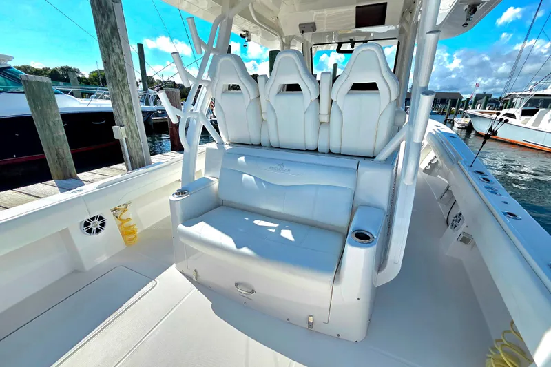  Yacht Photos Pics 2022 Regulator 37 boat interior with white seating and cup holders at a marina.