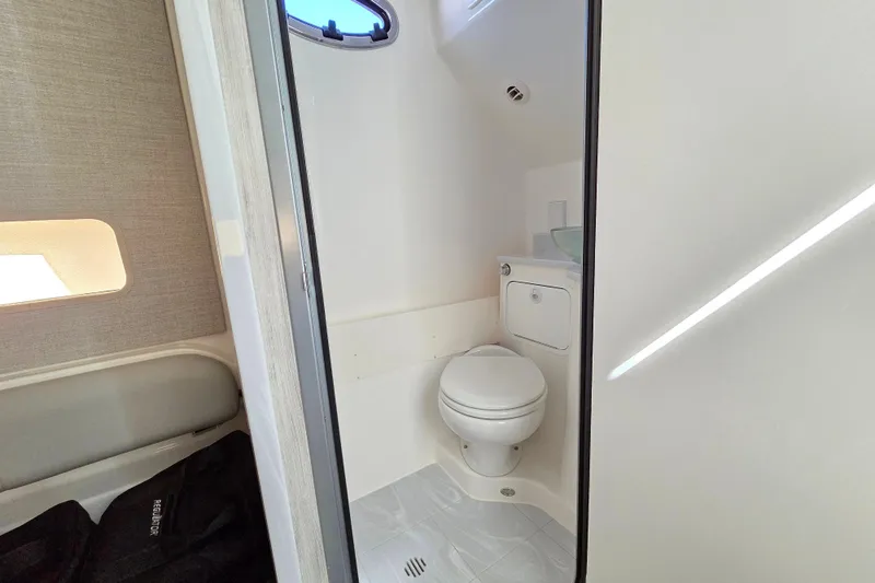  Yacht Photos Pics 2022 Regulator 37 boat bathroom interior with toilet and window.
