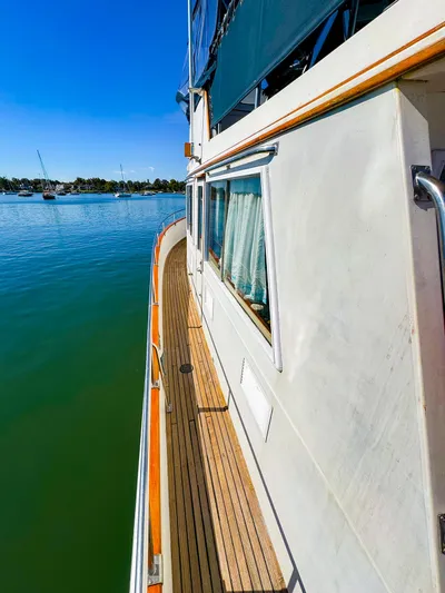 4796tw Yacht Photos Pics 1988 Grand Banks 42 Classic yacht on calm water, side deck view.