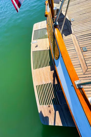 4796tw Yacht Photos Pics 1988 Grand Banks 42 Classic yacht stern with wooden swim platform on calm water.