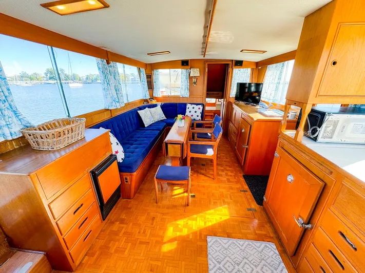 4796tw Yacht Photos Pics Interior of 1988 Grand Banks 42 Classic yacht with wood finish and blue seating.
