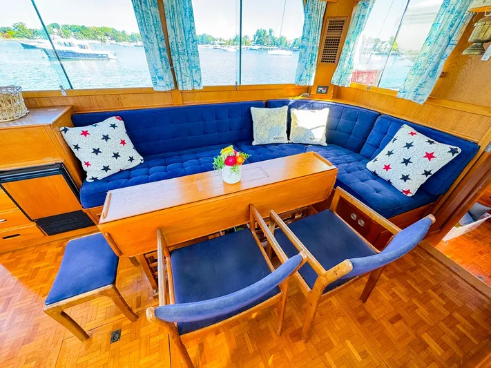 4796tw Yacht Photos Pics Interior of 1988 Grand Banks 42 Classic yacht with blue seating and wooden table.
