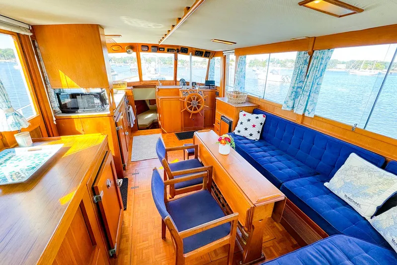 4796tw Yacht Photos Pics Interior of 1988 Grand Banks 42 Classic yacht with blue seating and wooden accents.
