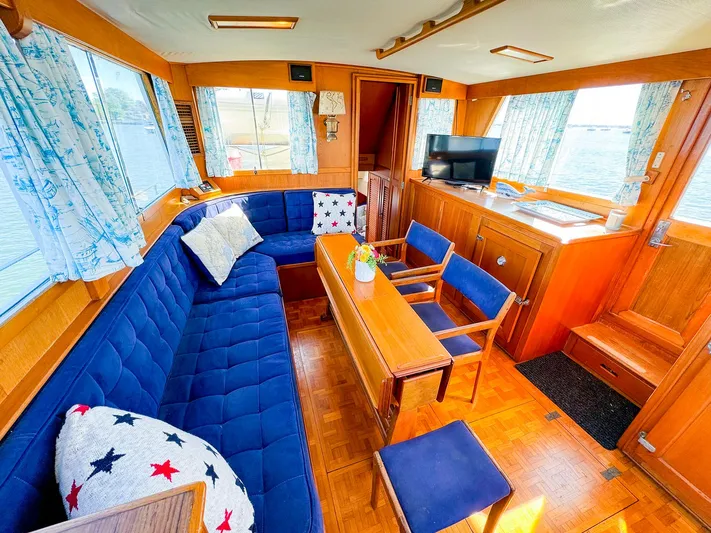 4796tw Yacht Photos Pics Interior of 1988 Grand Banks 42 Classic yacht with blue seating and wooden accents.