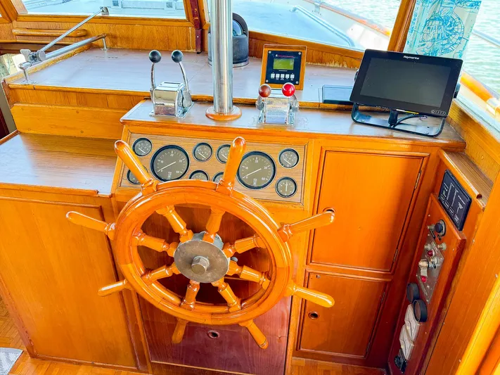 4796tw Yacht Photos Pics Wooden helm of 1988 Grand Banks 42 Classic yacht with navigation instruments.
