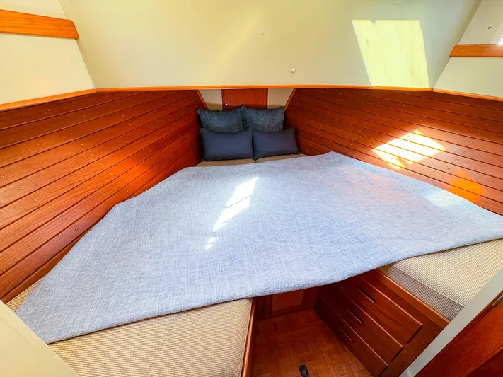 4796tw Yacht Photos Pics Cozy cabin interior of 1988 Grand Banks 42 Classic with wooden paneling and bedding.