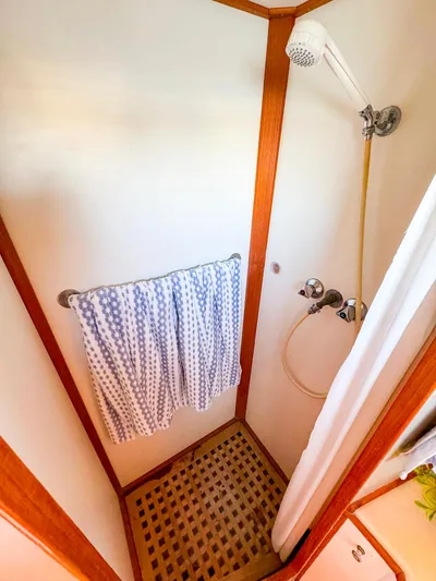 4796tw Yacht Photos Pics Shower area in 1988 Grand Banks 42 Classic yacht with wooden accents and towel rack.