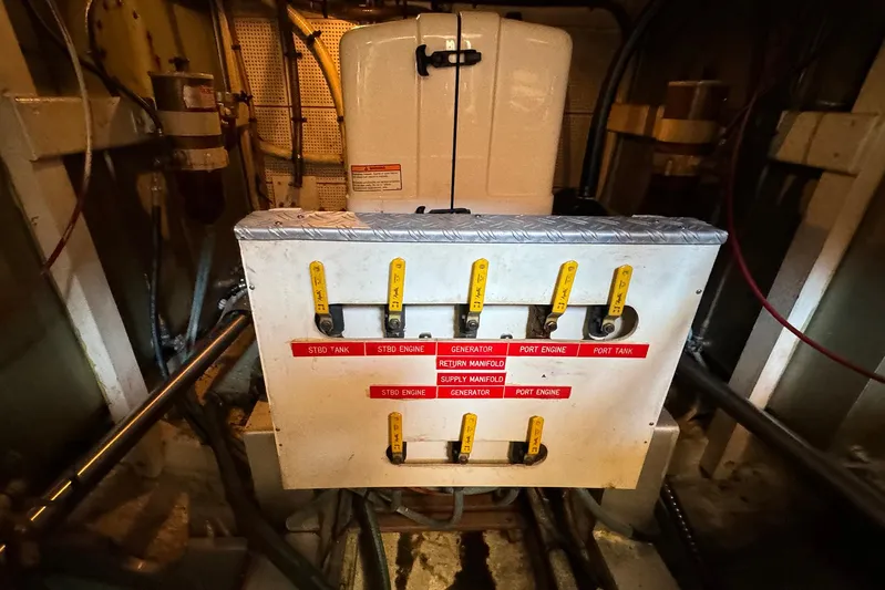 4796tw Yacht Photos Pics Engine room of 1988 Grand Banks 42 Classic with labeled control panel.