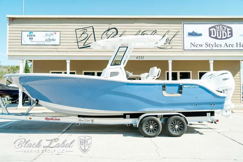 Black Label Marine Yacht Photos Pics 2025 Sea Fox 268 Commander boat on trailer, displayed outside a building.