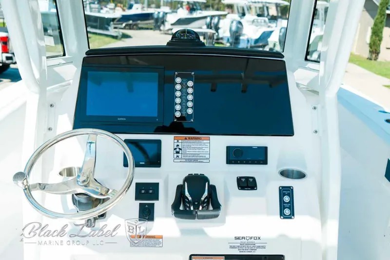 Black Label Marine Yacht Photos Pics Helm of 2025 Sea Fox 268 Commander boat with steering wheel and control panel.
