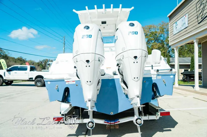 Black Label Marine Yacht Photos Pics 2025 Sea Fox 268 Commander boat with dual 200 horsepower engines, parked outdoors.