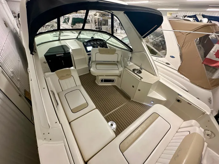  Yacht Photos Pics 2010 Sea Ray 310 Sundancer boat interior with seating and helm, featuring a sleek design.