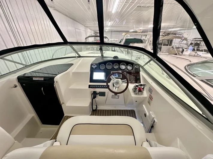  Yacht Photos Pics 2010 Sea Ray 310 Sundancer cockpit with steering wheel, control panel, and navigation equipment.