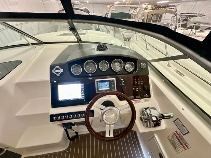  Yacht Photos Pics 2010 Sea Ray 310 Sundancer helm with gauges, steering wheel, and navigation controls.
