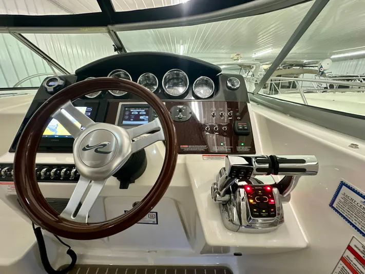 Yacht Photos Pics Helm of 2010 Sea Ray 310 Sundancer with steering wheel and control panel.