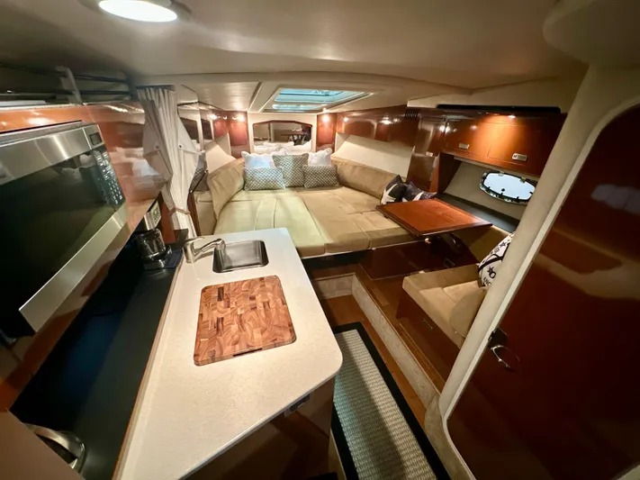  Yacht Photos Pics Interior of 2010 Sea Ray 310 Sundancer yacht with kitchen and seating area.