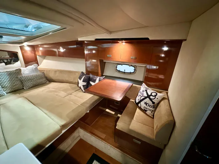  Yacht Photos Pics Luxurious interior of 2010 Sea Ray 310 Sundancer with cozy seating and elegant wood finish.