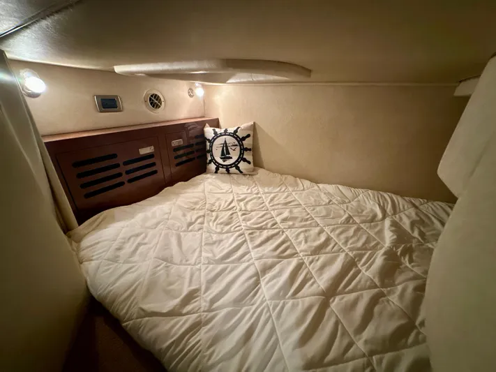  Yacht Photos Pics Cozy cabin interior of 2010 Sea Ray 310 Sundancer with nautical-themed pillow.