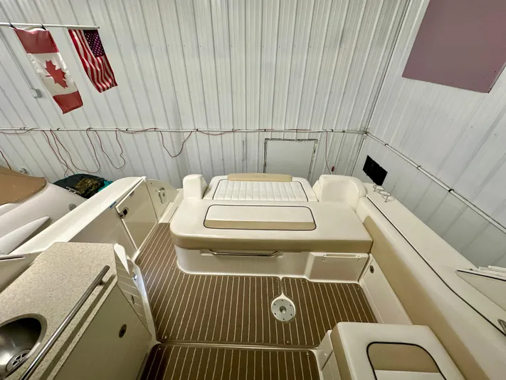  Yacht Photos Pics 2010 Sea Ray 310 Sundancer interior with seating and kitchenette, featuring Canadian and American flags.