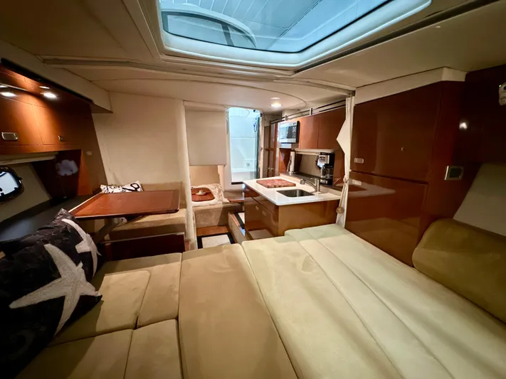  Yacht Photos Pics Luxurious interior of 2010 Sea Ray 310 Sundancer yacht with kitchen and seating area.