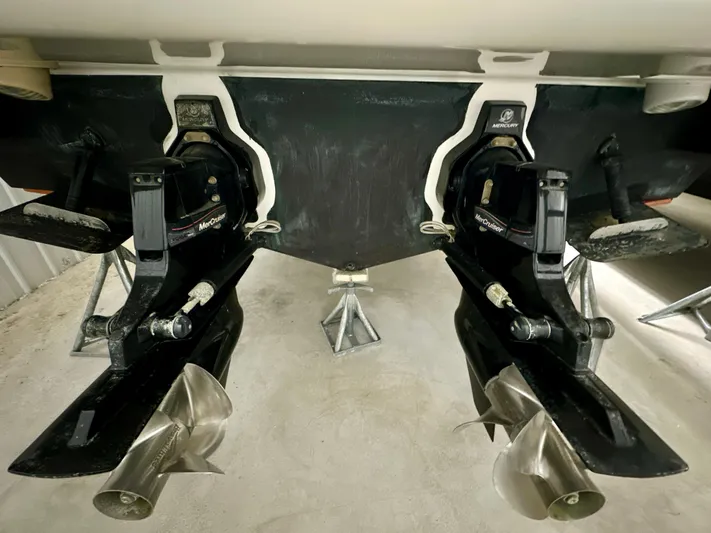  Yacht Photos Pics 2010 Sea Ray 310 Sundancer boat propellers and stern drives in a storage area.