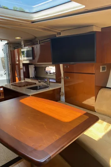  Yacht Photos Pics Interior of 2010 Sea Ray 310 Sundancer with modern kitchen and dining area.