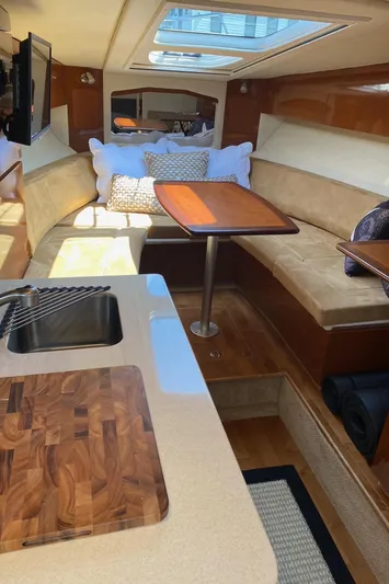  Yacht Photos Pics Interior of 2010 Sea Ray 310 Sundancer yacht with cozy seating and kitchenette.
