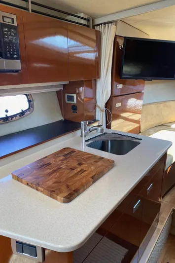  Yacht Photos Pics Interior of 2010 Sea Ray 310 Sundancer yacht with kitchenette and modern amenities.