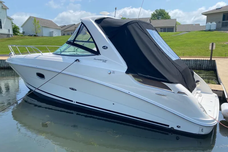  Yacht Photos Pics 2010 Sea Ray 310 Sundancer boat docked, featuring sleek design and black canopy.