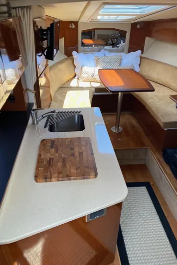  Yacht Photos Pics Interior of 2010 Sea Ray 310 Sundancer yacht with kitchenette and seating area.