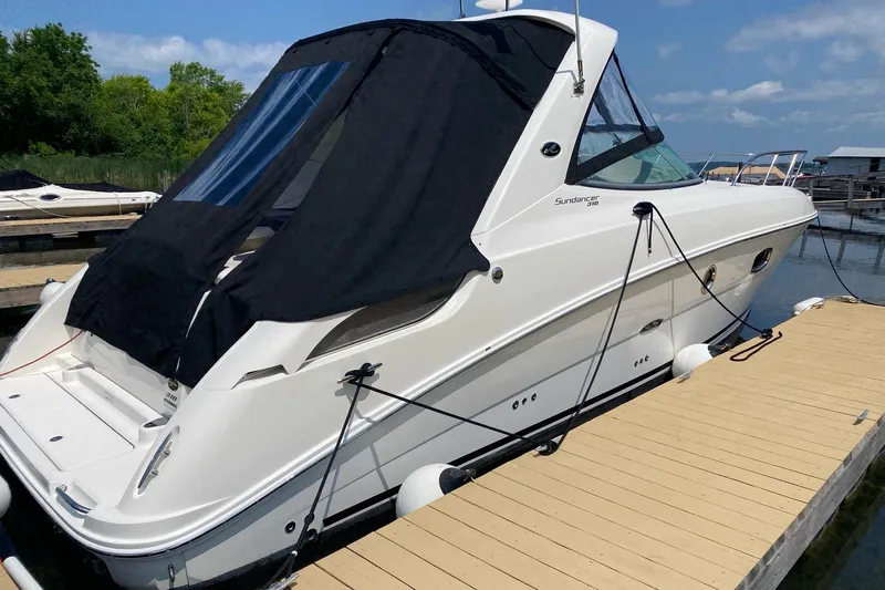  Yacht Photos Pics 2010 Sea Ray 310 Sundancer docked, featuring sleek design and black canopy.