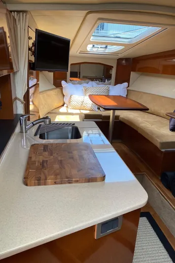  Yacht Photos Pics Interior of 2010 Sea Ray 310 Sundancer yacht with kitchenette and seating area.