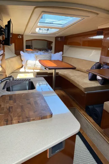  Yacht Photos Pics Interior of 2010 Sea Ray 310 Sundancer yacht with cozy seating and kitchenette.