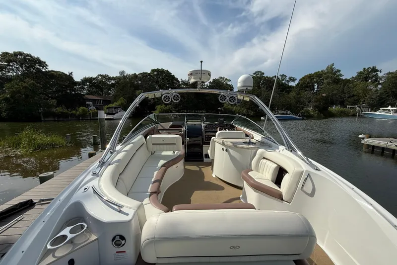  Yacht Photos Pics 2013 Cobalt 323 boat with spacious seating, docked by a scenic riverside.