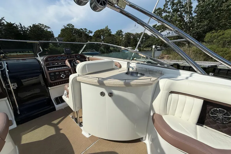  Yacht Photos Pics Luxurious 2013 Cobalt 323 boat interior with helm, sink, and plush seating.