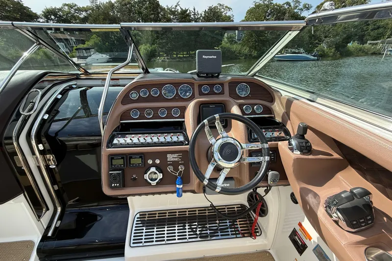  Yacht Photos Pics 2013 Cobalt 323 boat dashboard with steering wheel, controls, and navigation system.