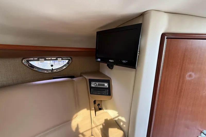  Yacht Photos Pics Interior of 2013 Cobalt 323 boat with TV and porthole window.