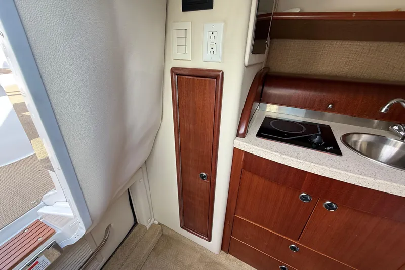  Yacht Photos Pics Interior of 2013 Cobalt 323 boat with kitchenette, stove, and sink.
