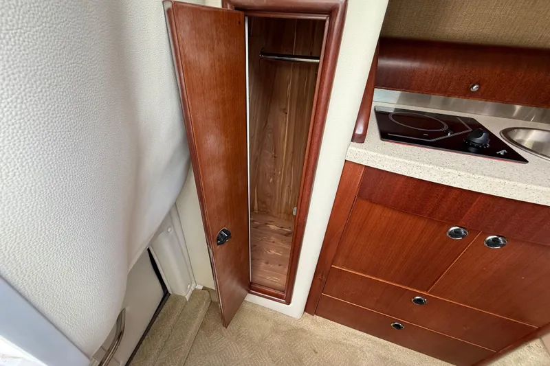  Yacht Photos Pics 2013 Cobalt 323 interior with wooden cabinet and compact kitchen area.