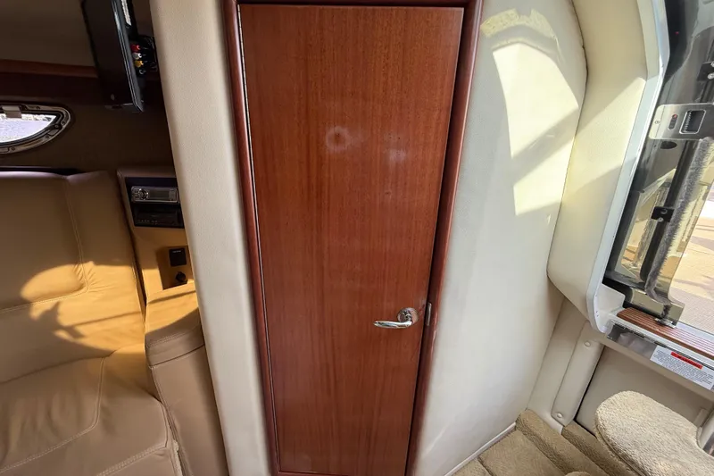  Yacht Photos Pics Interior of 2013 Cobalt 323 boat with wooden door and beige seating.