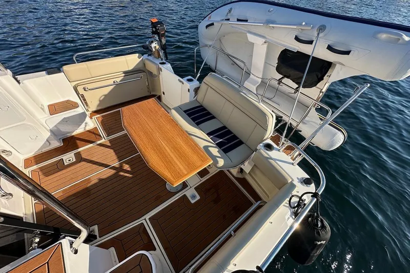 Buoy Boys Yacht Photos Pics 2025 Ranger Tugs R-29 CB boat deck with seating, table, and water view.