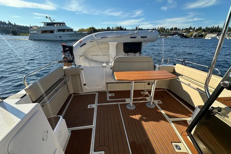 Buoy Boys Yacht Photos Pics 2025 Ranger Tugs R-29 CB boat interior with wooden deck and seating area.